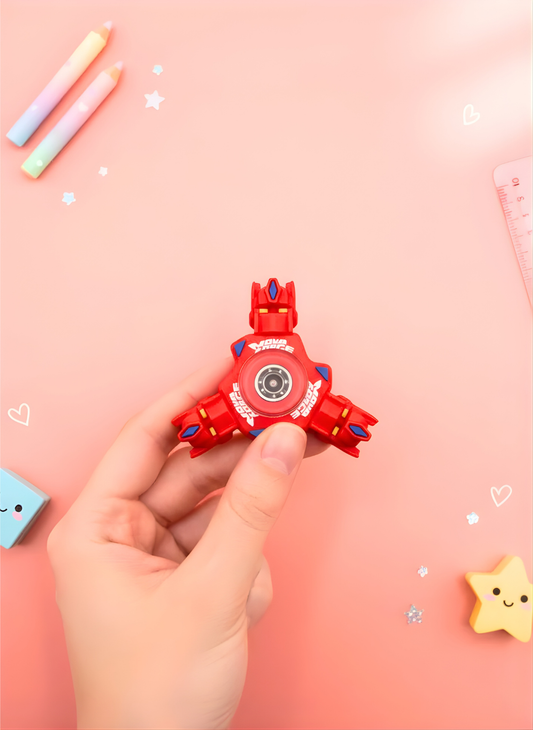 Red fidget spinner held by a hand on a pink background with decorative elements