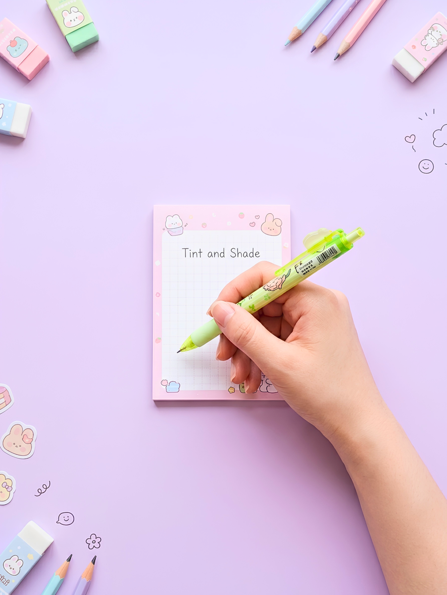 Hand holding a green marker over a notepad with 'Tint and Shade' on a purple background