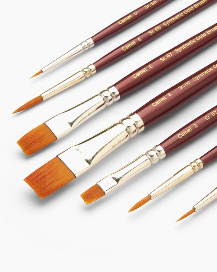 Set of Camel synthetic gold brushes on a white background