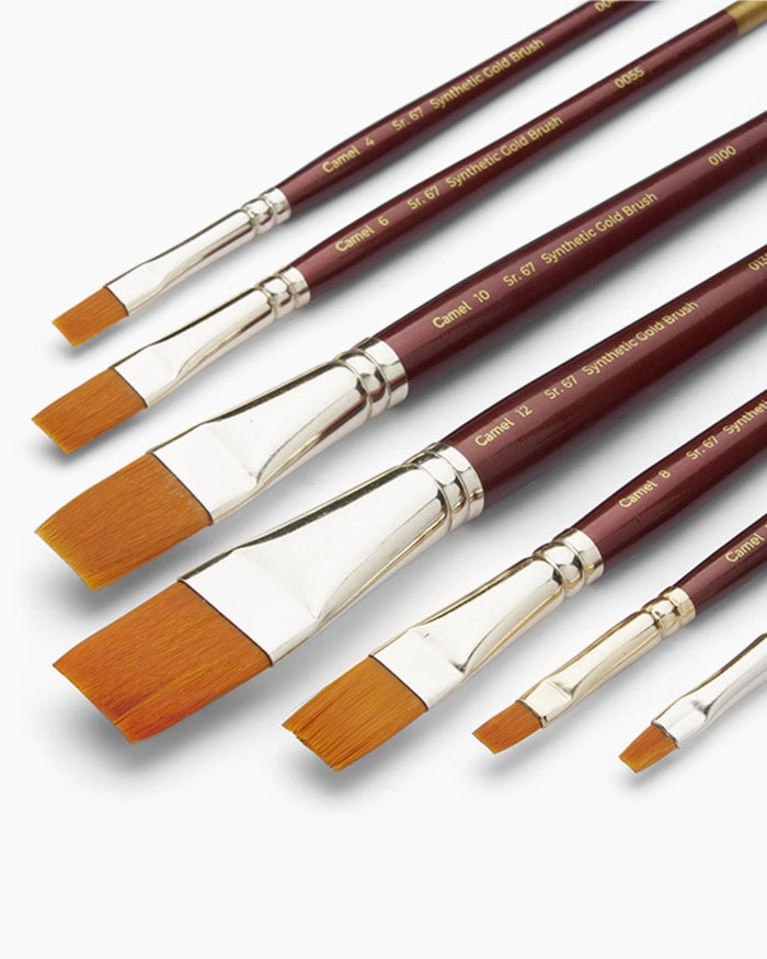 Set of paintbrushes with wooden handles and gold accents on a white background