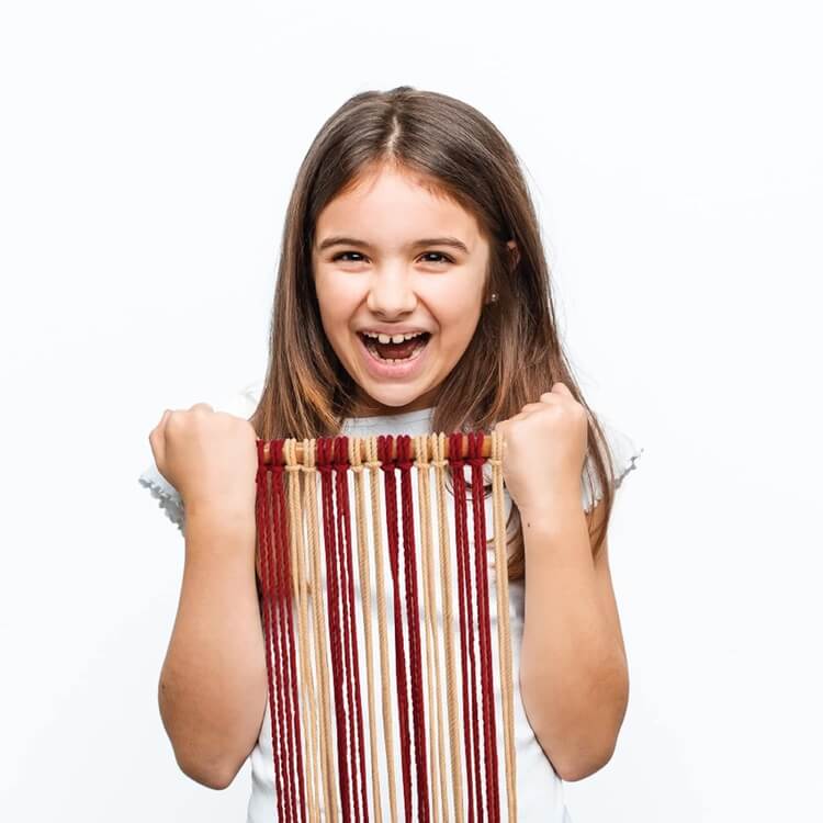 Young girl holding a striped fabric against a white background
