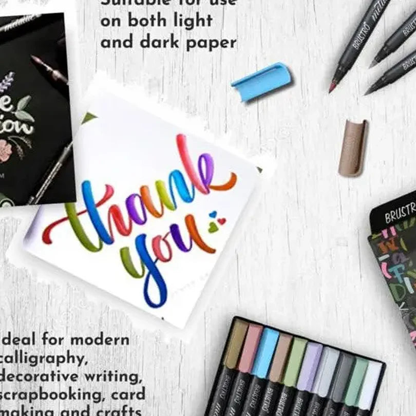 Colorful 'thank you' card with markers and a rubber on a white surface