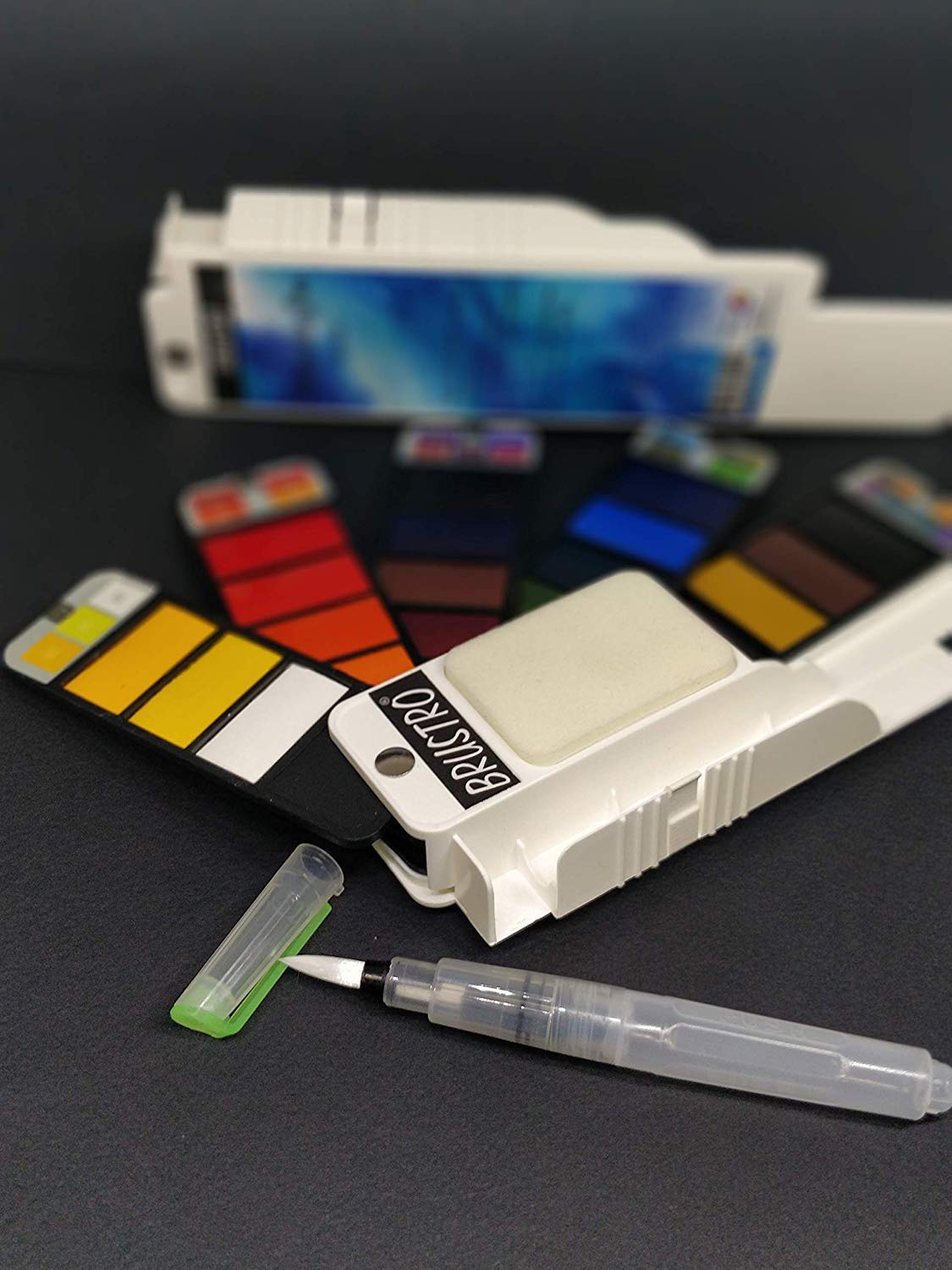 Brustro watercolor pan set with a brush on a dark surface
