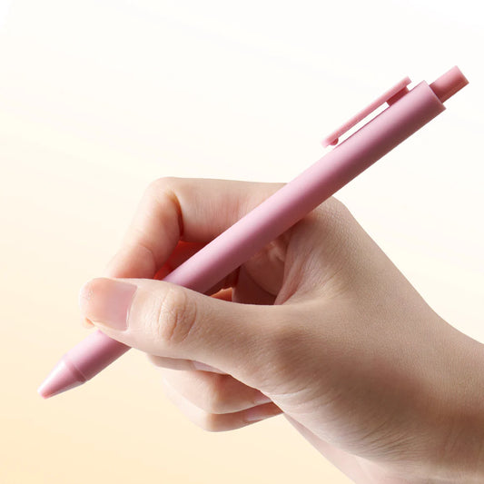 Hand holding a pink pen against a light background