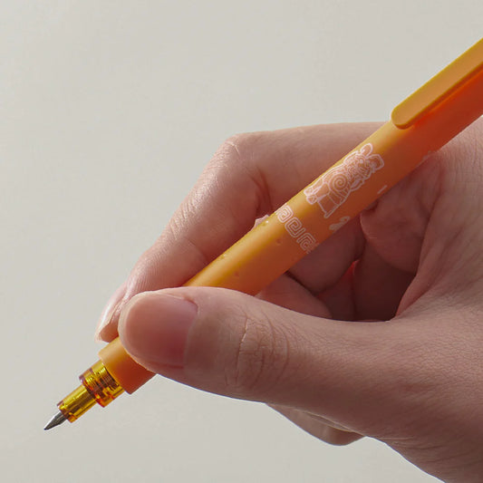 Hand holding an orange pen with a clear cap against a light gray background