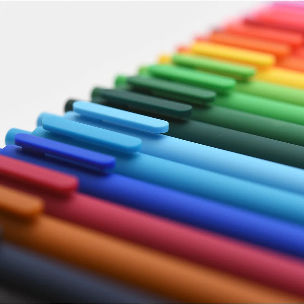 Colorful markers arranged in a row on a light background