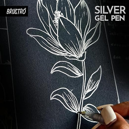 Hand drawing a floral design on black paper with a silver gel pen, featuring the brand 'BRUSTRO'.