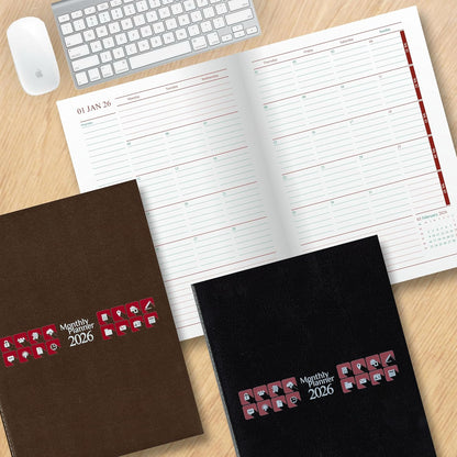 Two planners, one brown and one black, with 'Monthly Planner 2026' text on a wooden surface with a keyboard and mouse.