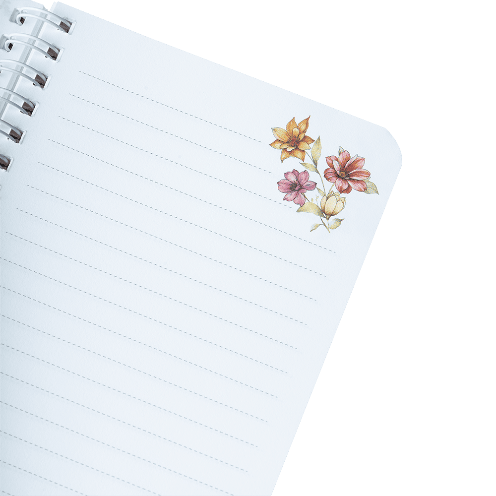 Notebook with floral stickers on a green background