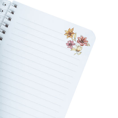 Notebook with floral stickers on a green background