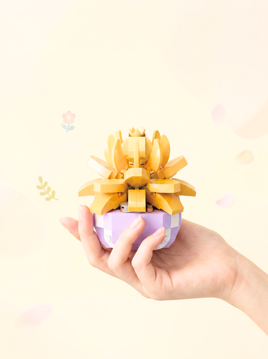 Hand holding a small purple container with a yellow flower-like structure on a light background