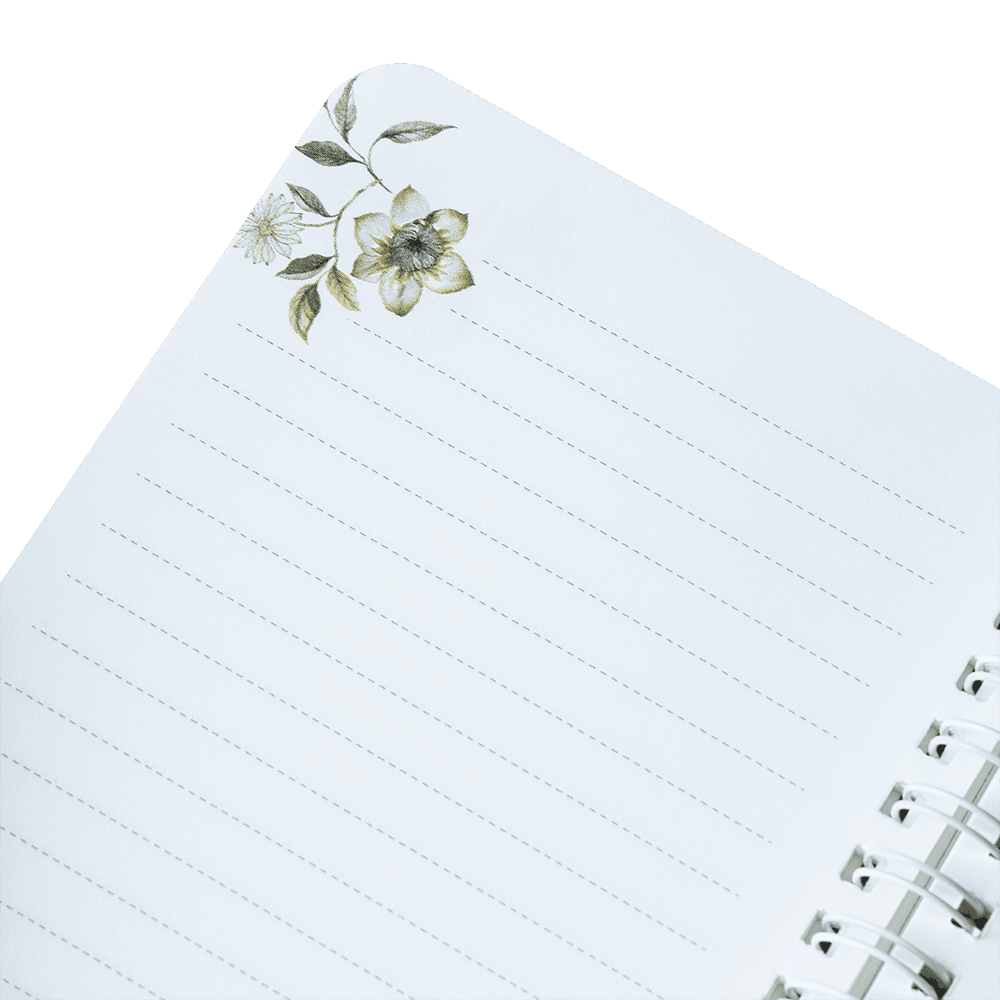 Notebook with floral design on the cover against a green background