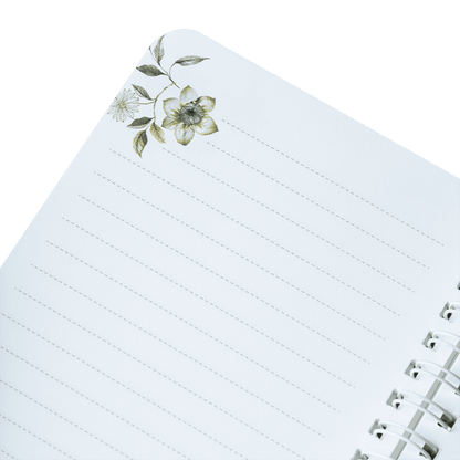 Notebook with floral design on the cover against a green background
