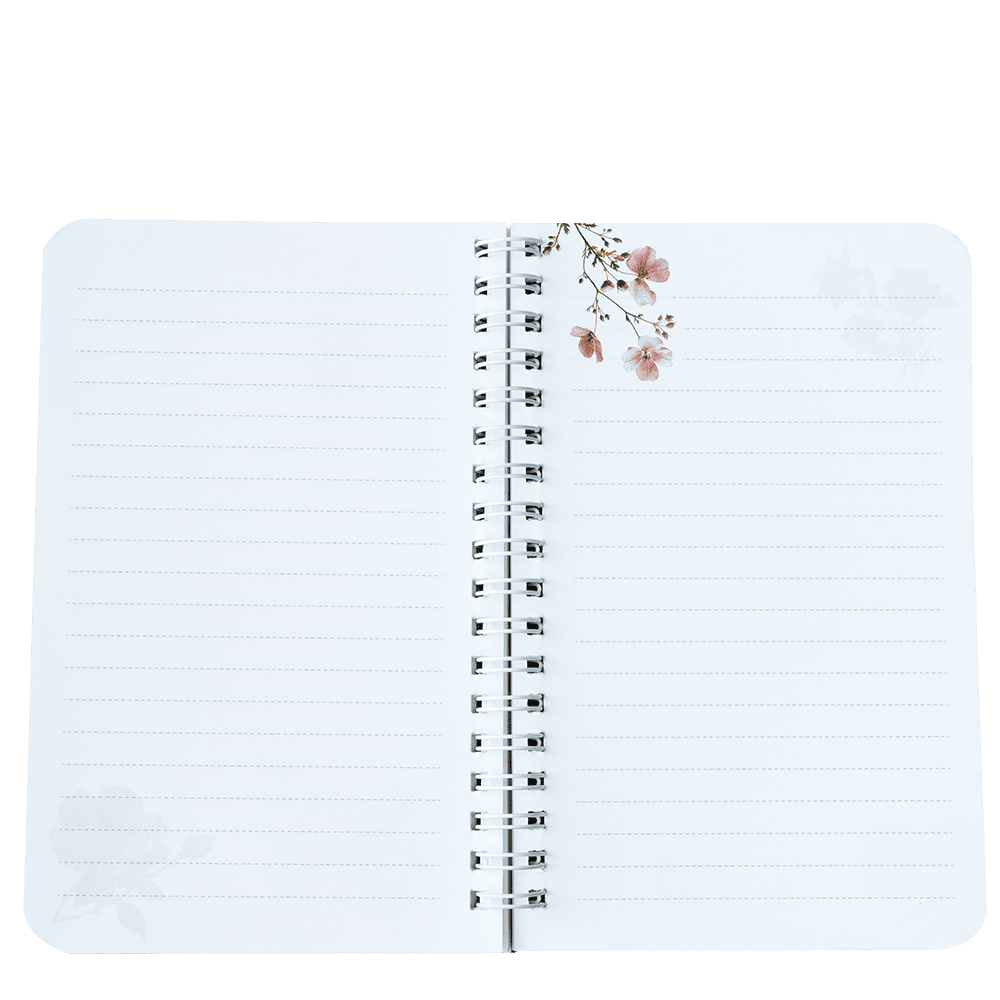 Open notebook with lined pages and floral design on a white background