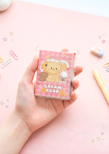Hand holding a pink jelly cutie with cream bear design on a pink background