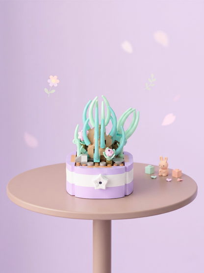 Small decorative garden with plants on a round table against a light purple background