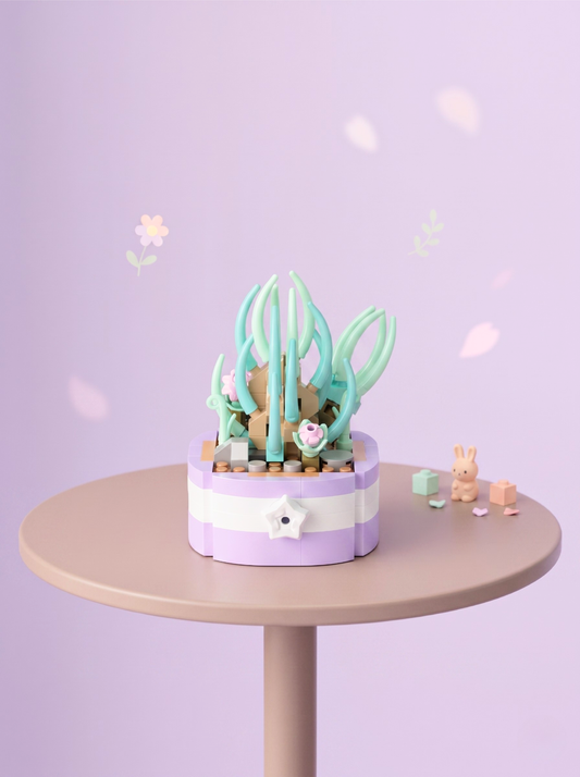 Small decorative garden with plants on a round table against a light purple background