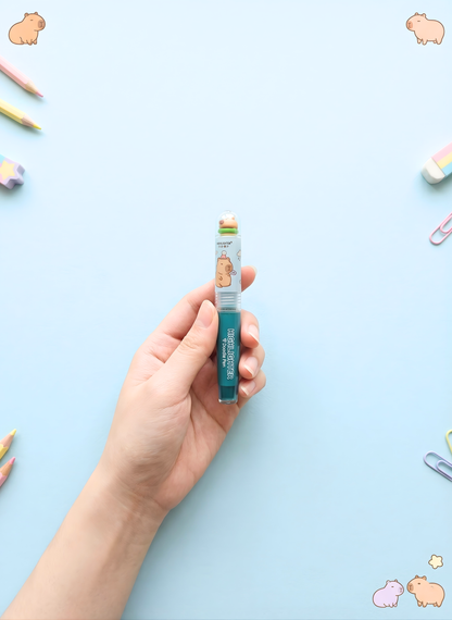 Hand holding a small product against a light blue background