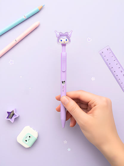 Hand holding a purple cartoon-themed pen on a light purple background with stationery items.
