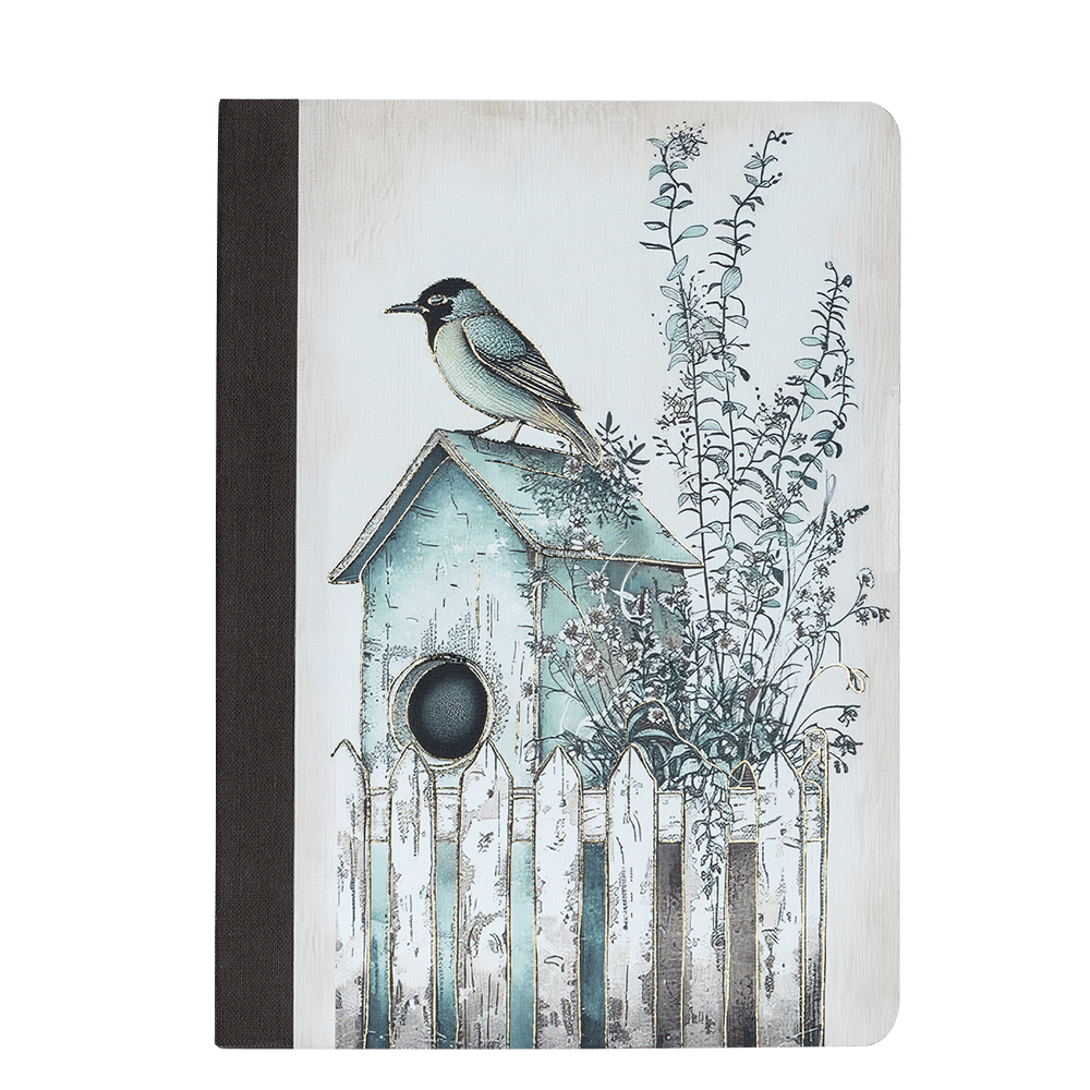 Notebook with a birdhouse and bird illustration on the cover against a green background