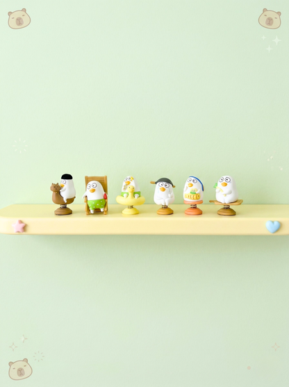 Set of small figurines on a shelf against a light green background