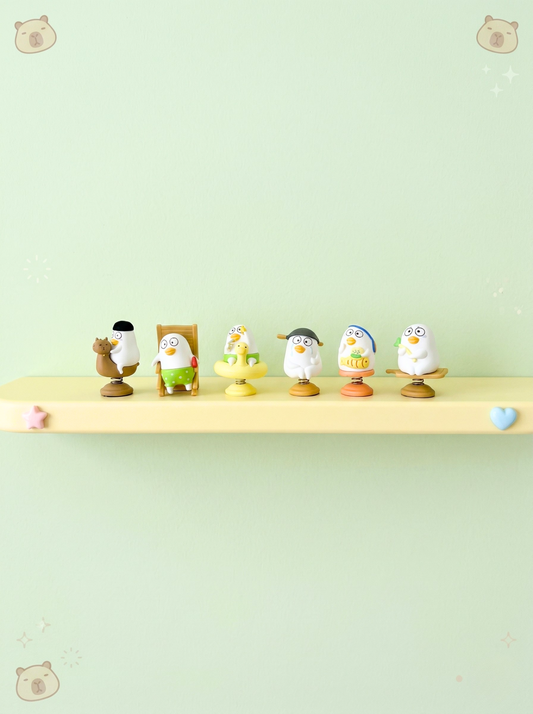 Set of small figurines on a shelf against a light green background