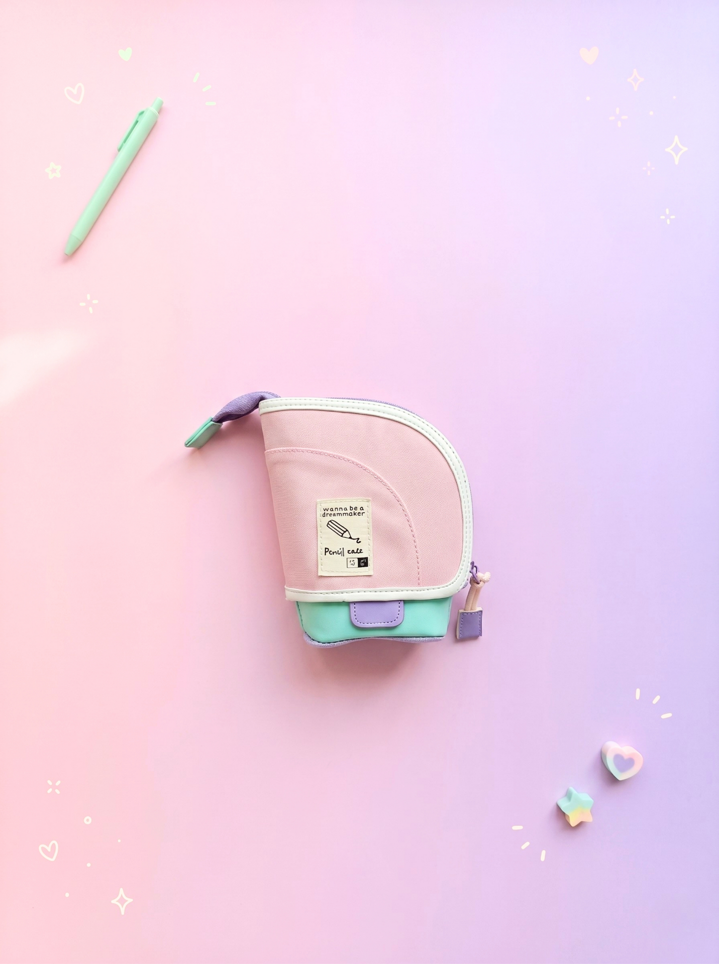 Small pink and green pouch on a gradient pink and purple background