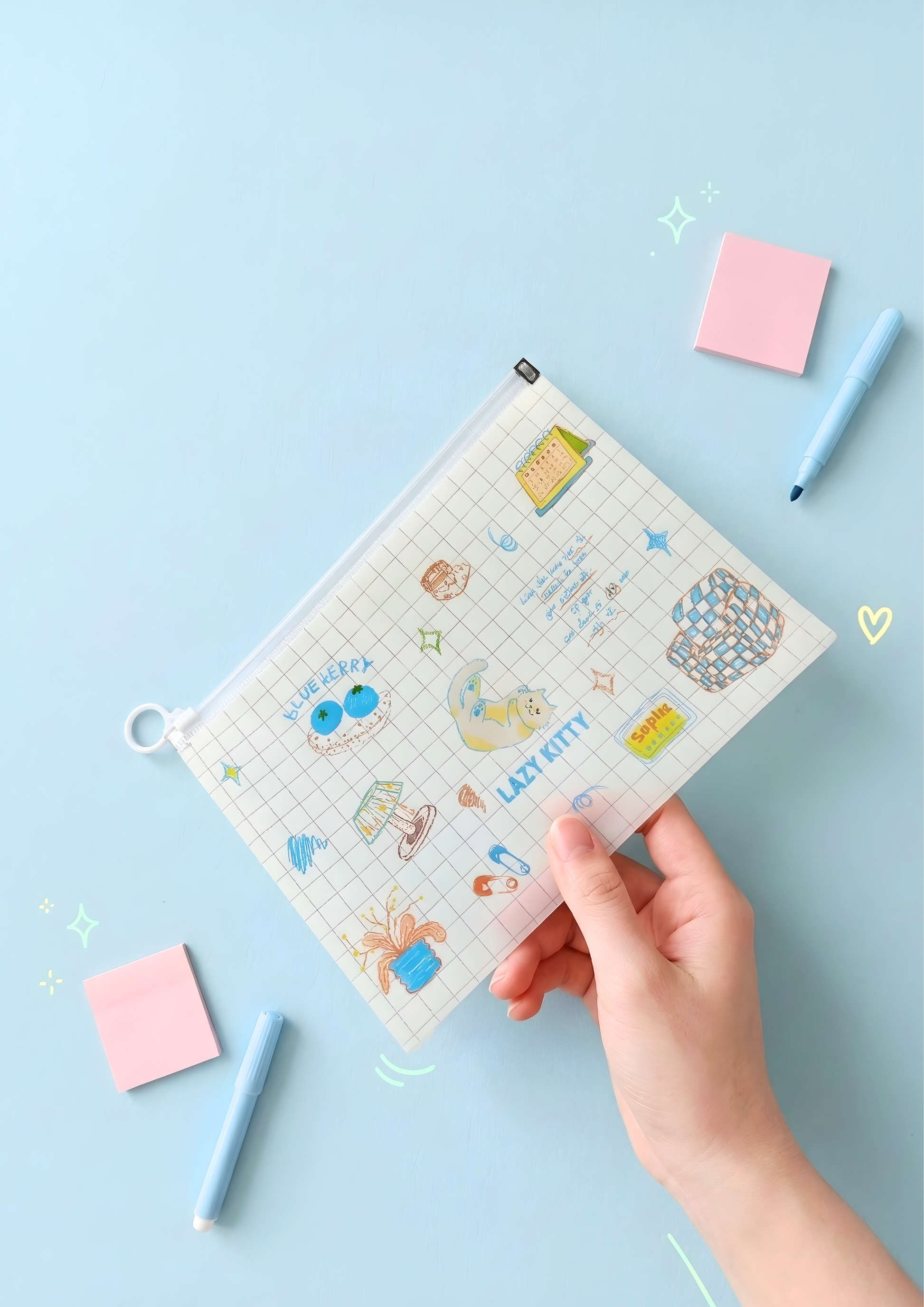 Person holding a small file with cartoon designs on a light blue background