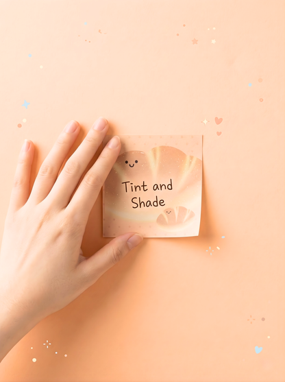 Hand holding a sticky note with 'Tint and Shade' text on a beige background
