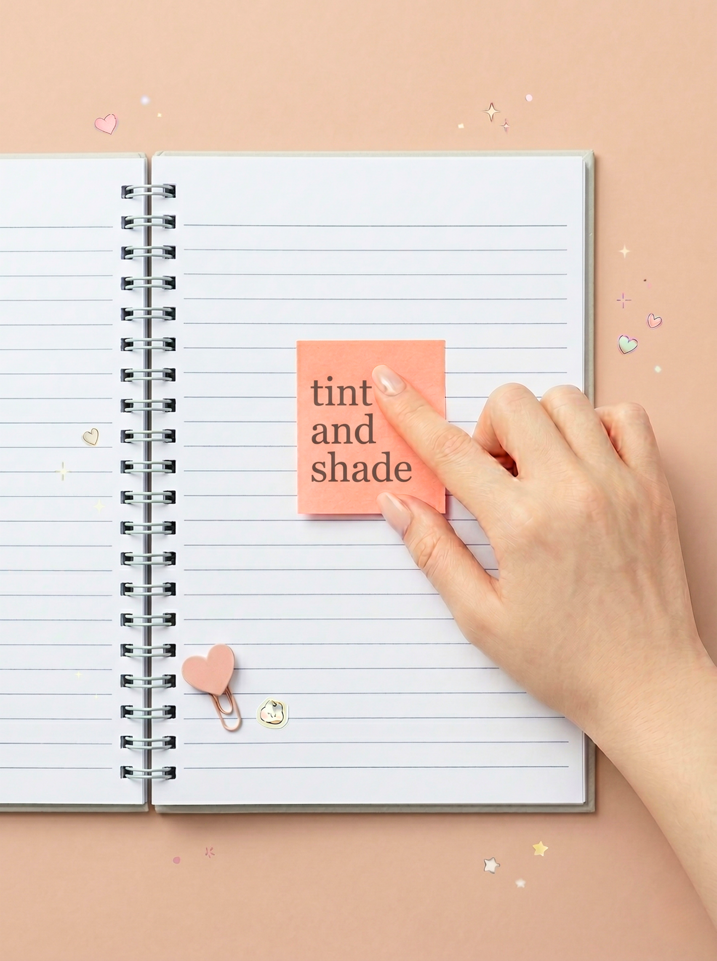 Hand placing a pink sticky note on a lined notebook with 'tint and shade' text.