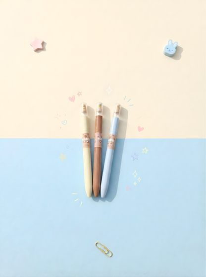 Three colorful pens on a two-tone blue and beige background with small decorative items.