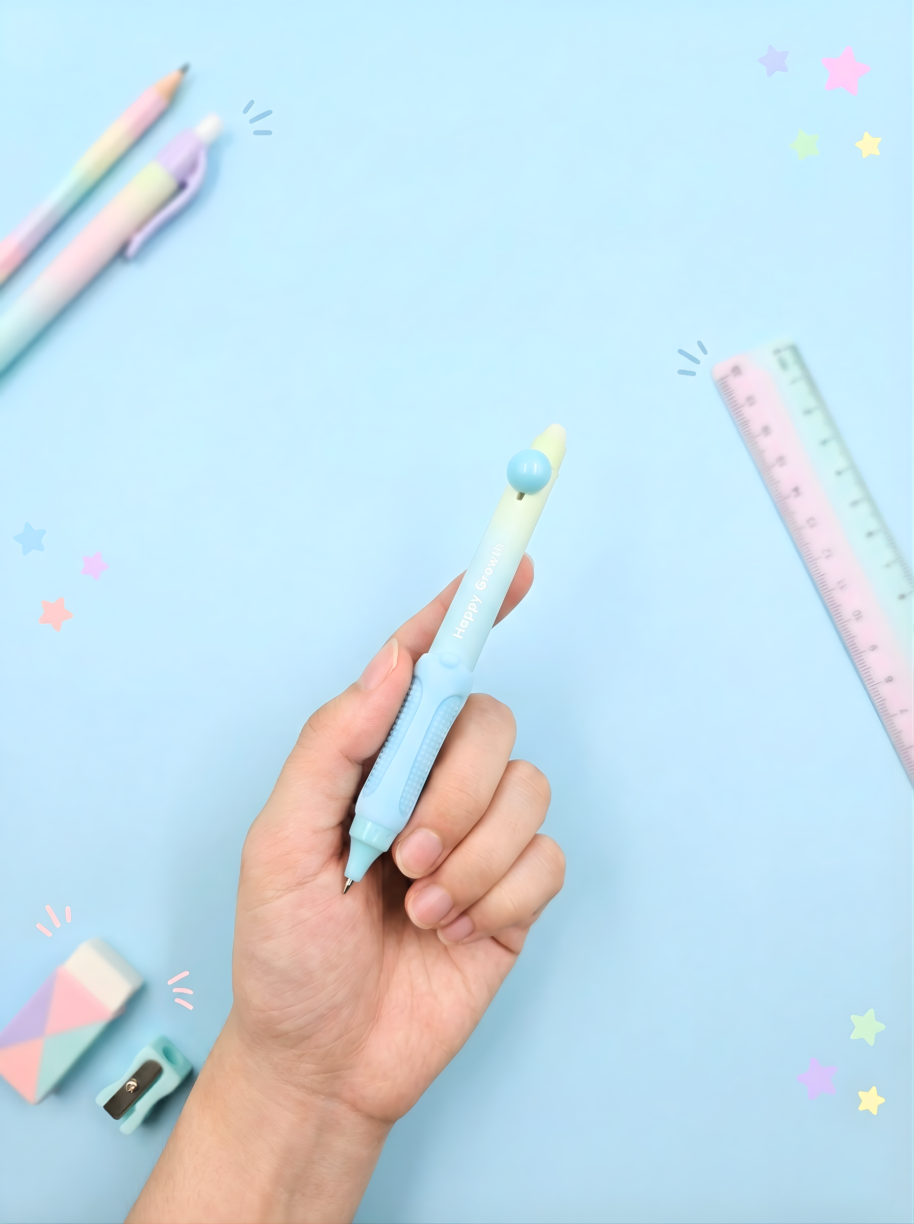 Hand holding a light blue pen with colorful accents on a light blue background