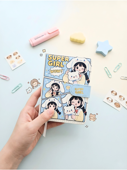 Sticker book with cartoon character and 'Super Girl' text held by a hand on a light background with decorative items.