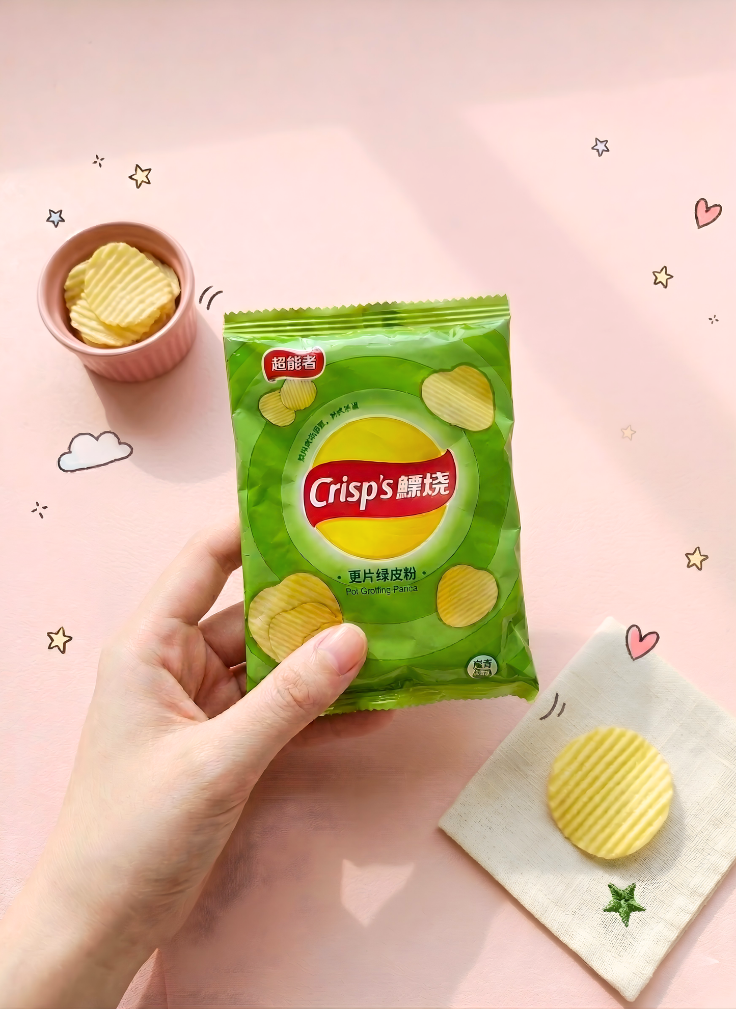 Hand holding a green packet of Crisps brand chips on a pink background