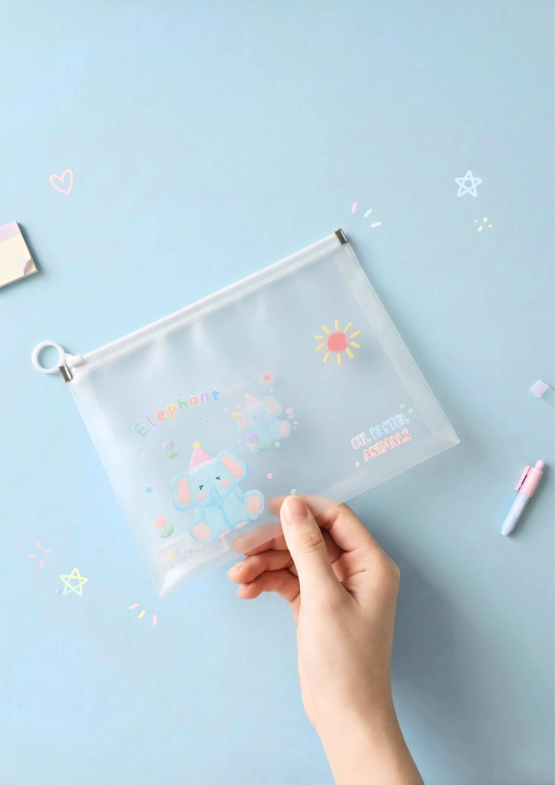 Clear pouch with colorful designs held by a hand on a light blue background