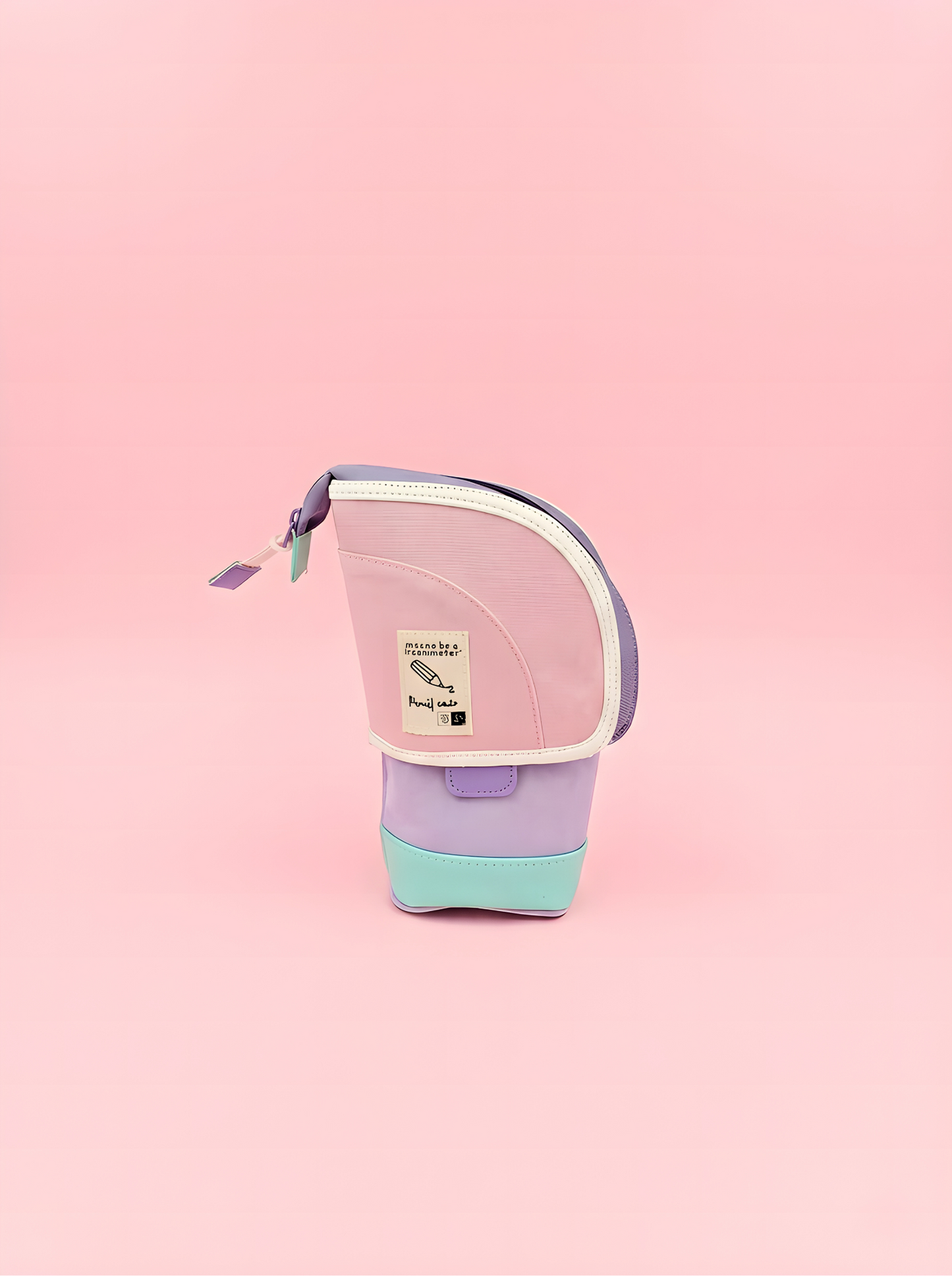 Small pink and purple bag with a visible brand label on a pink background