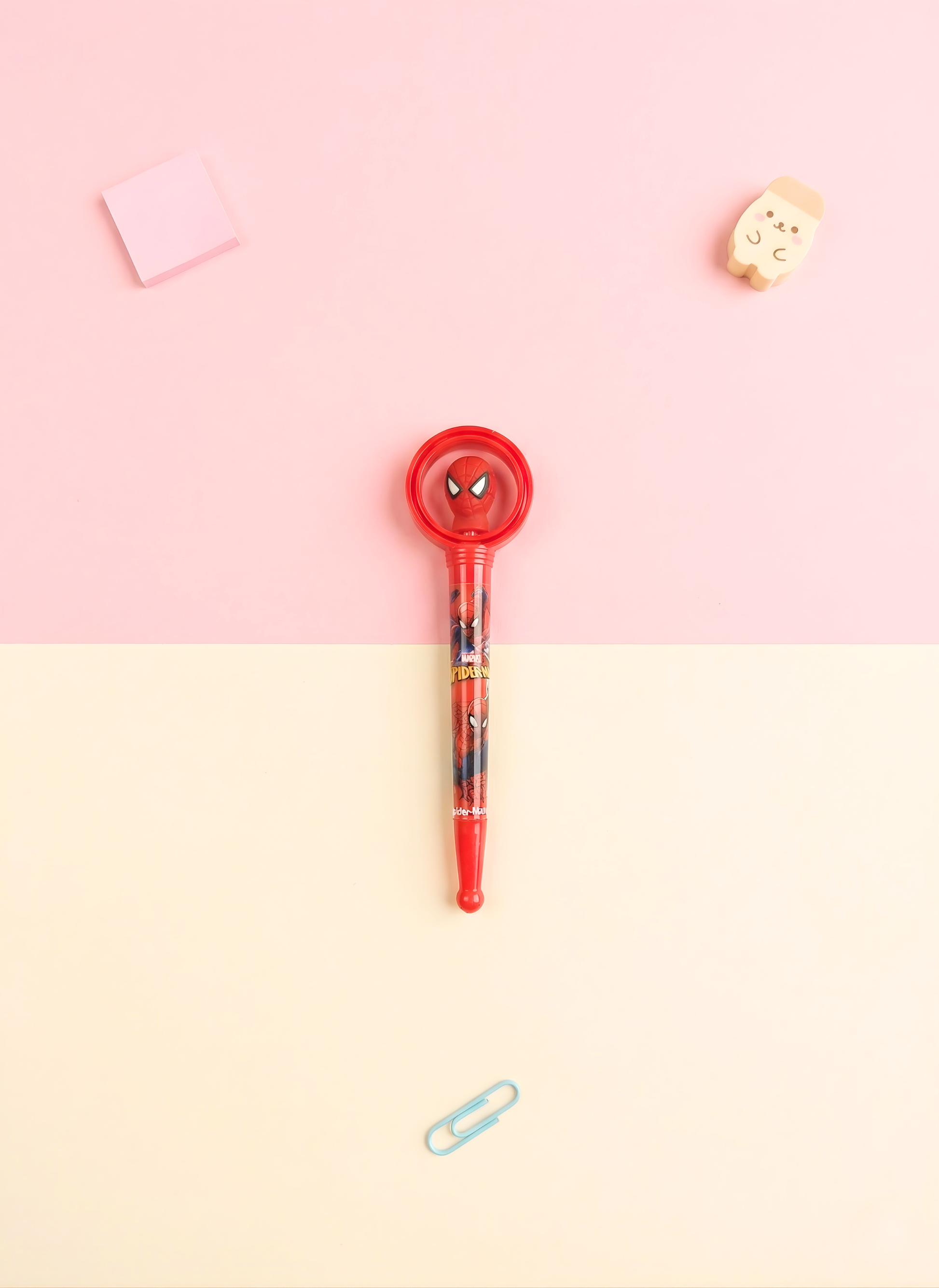 Pen with Spider-Man design on a pink and beige gradient background