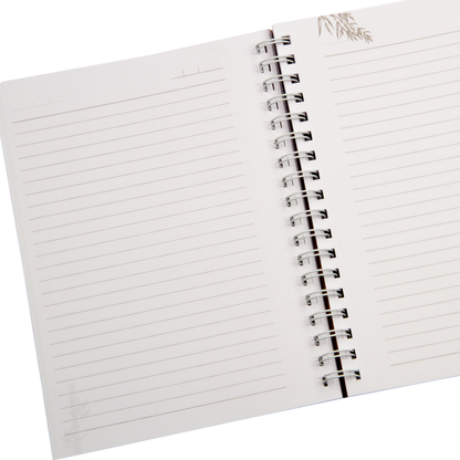 Open spiral-bound notebook with lined pages on a white background