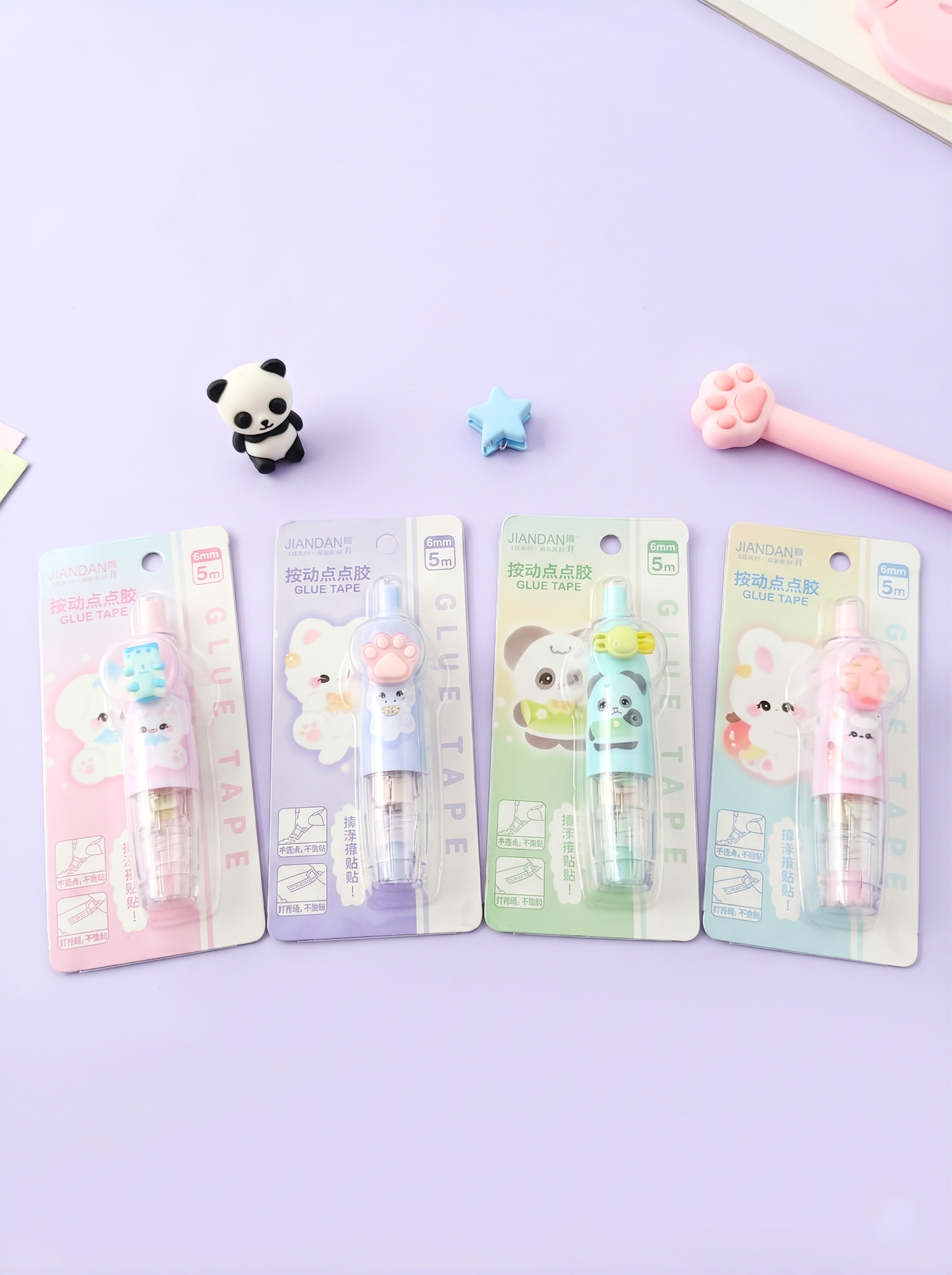 Four cartoon-themed修正带 (correcting tape) packages on a purple background