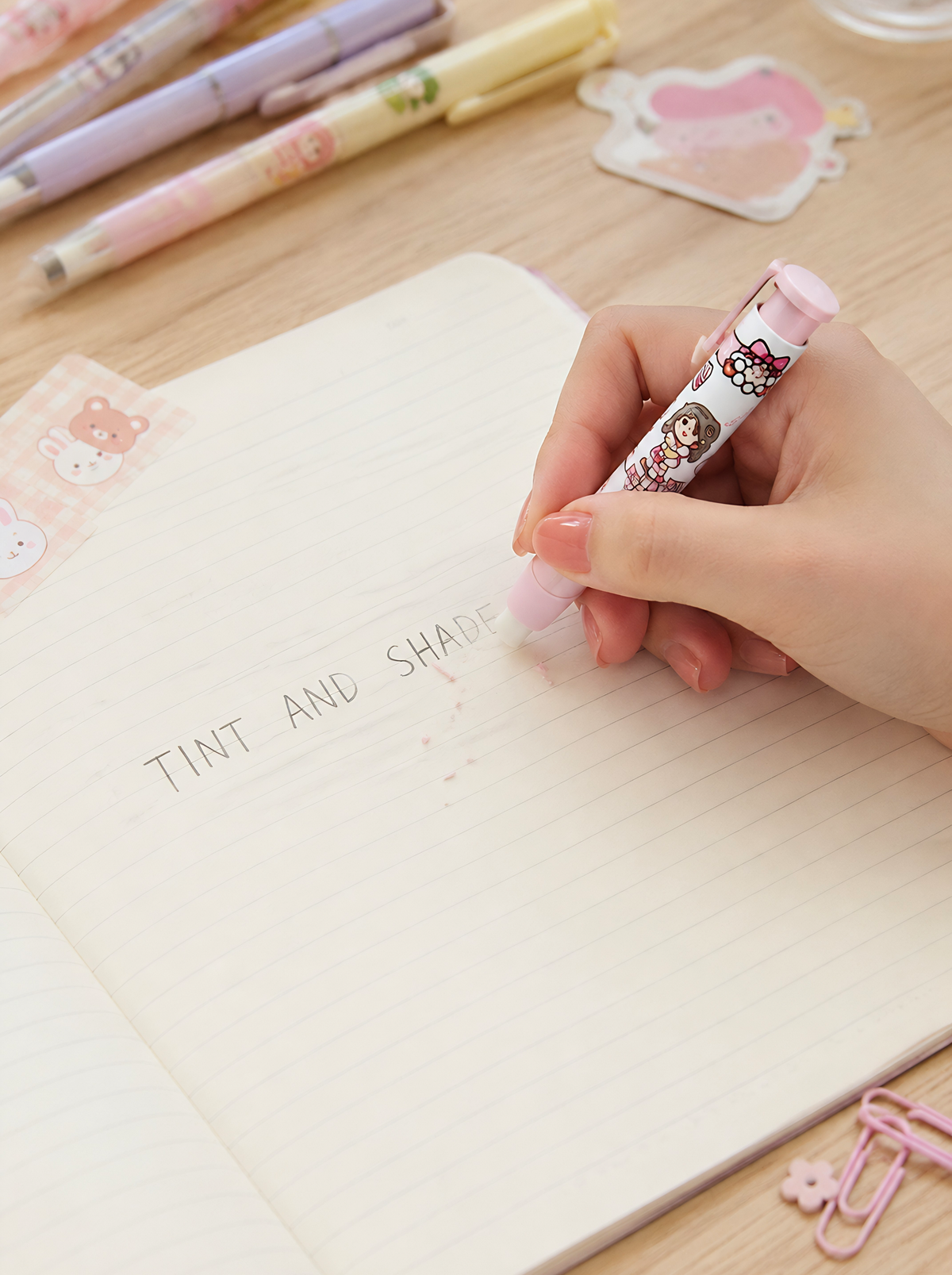 Hand holding a colorful pen over a notebook with 'Tint and Shade' text.
