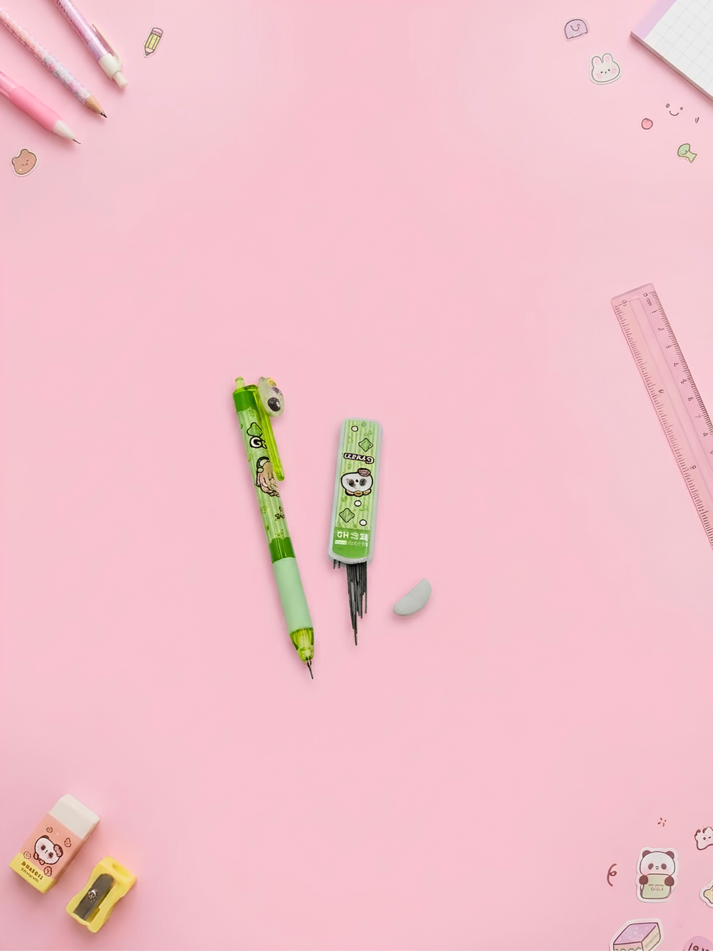 Green pens with cartoon characters on a pink background