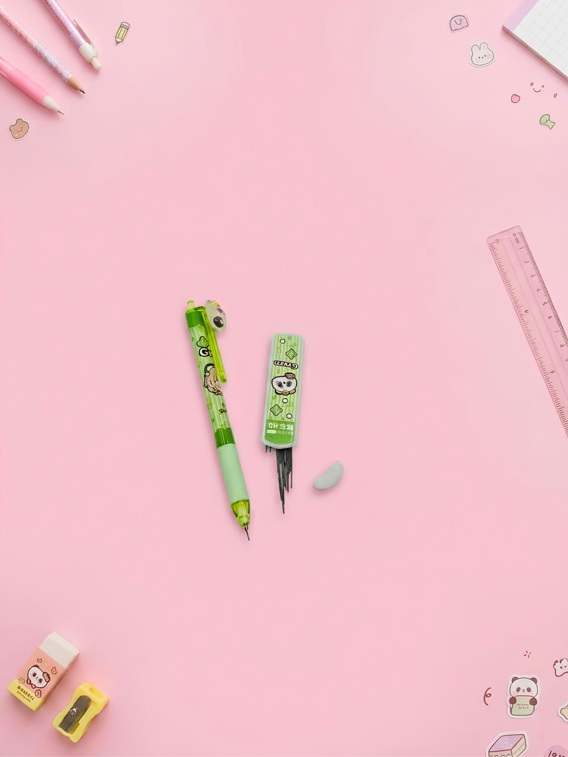 Green pens with cartoon characters on a pink background
