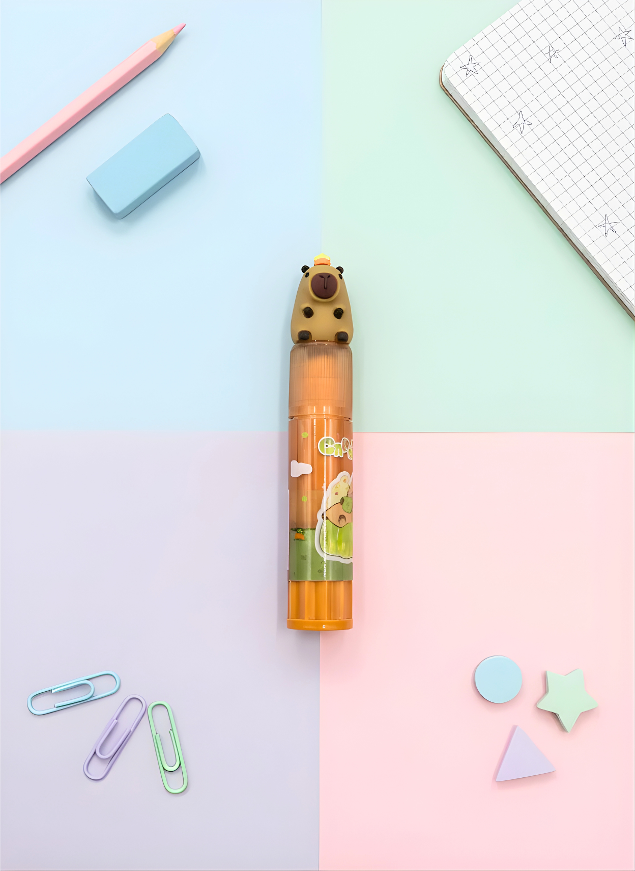 Cute animal-themed pen on a colorful background with stationery items