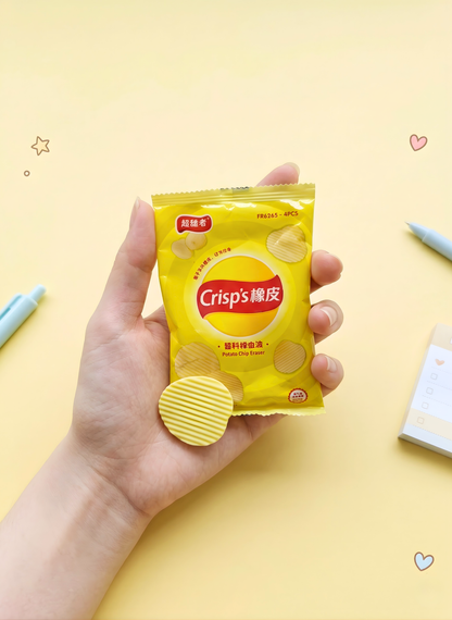 Hand holding a packet of Crisps'饼干 on a yellow background