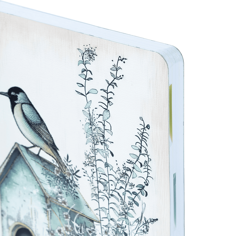 Illustration of a bird on a birdhouse with plants on a notebook cover.