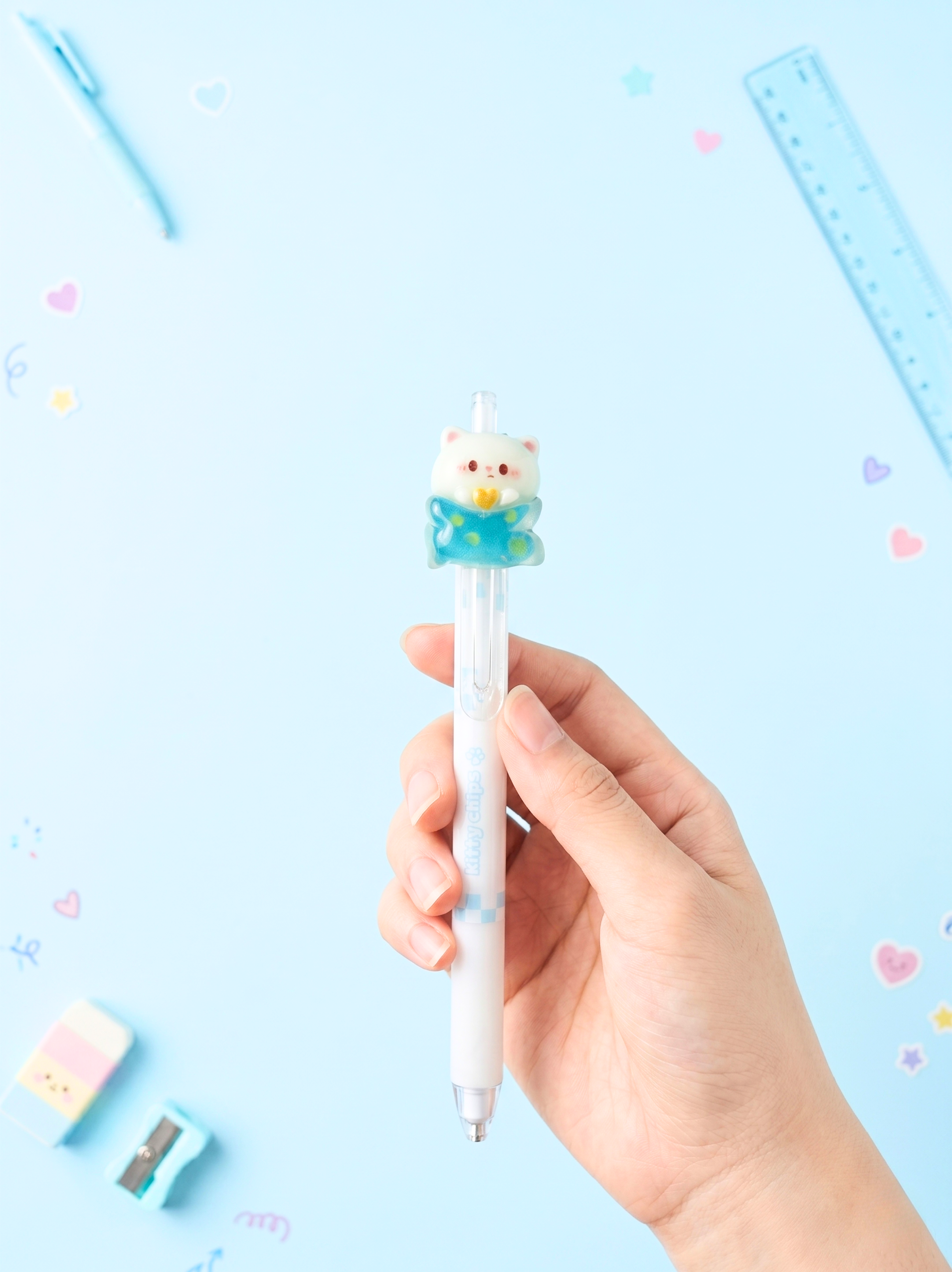 Hand holding a cute animal-shaped pen with a light blue background