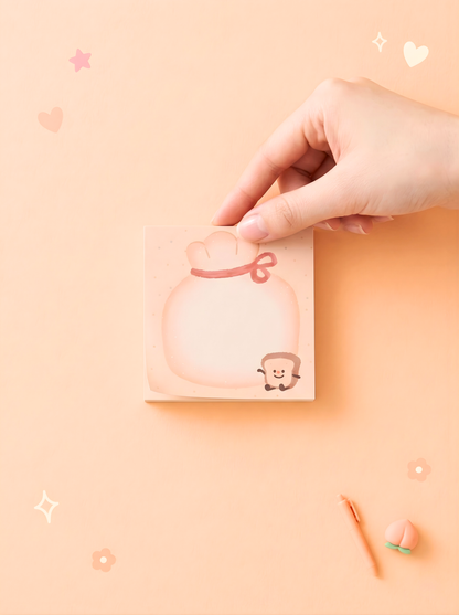 Hand holding a pink product with a cartoon character on a peach-colored background