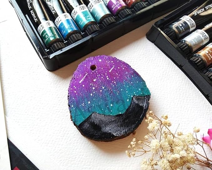 Colorful painted ornament with acrylic paint sets on a white surface