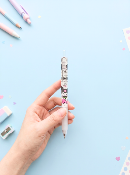 Hand holding a decorative pen with cartoon character on a light blue background