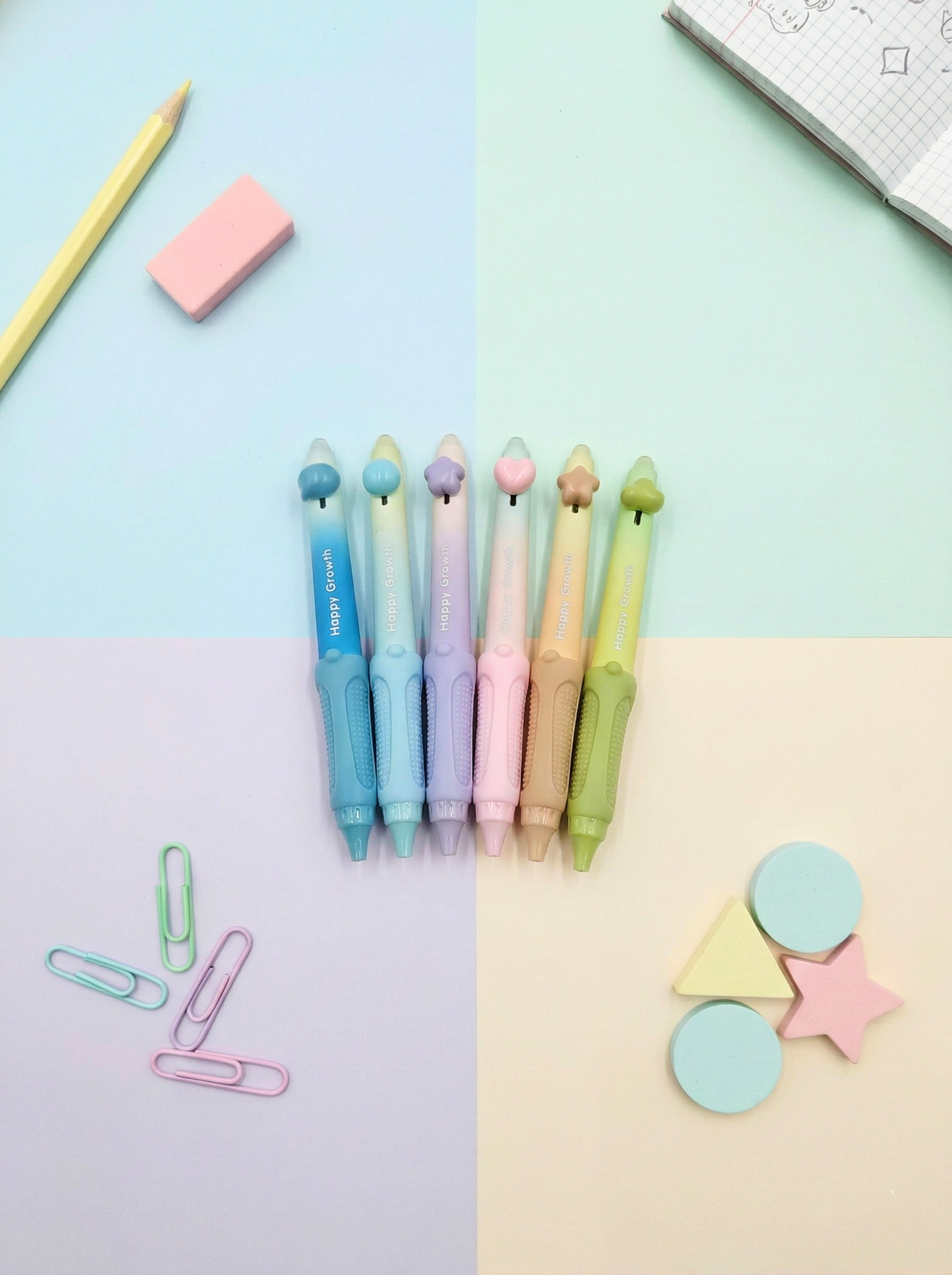 Colorful stationery items including pens, paper clips, and geometric shapes on a pastel gradient background.